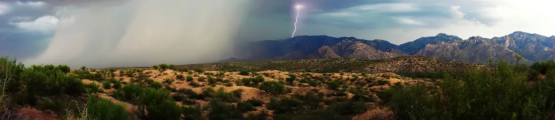 Pouring rain and lightning moving over a mountainscape